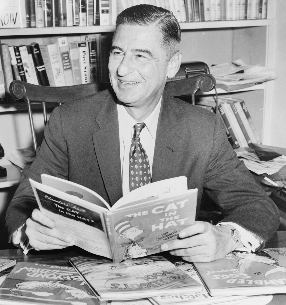 Dr. Seuss poses with The Cat in the Hat and other books, c. 1957