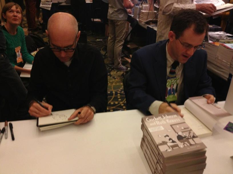 Daniel Clowes and Philip Nel signing books at the Fantagraphics booth. Photo by Alvin Buenaventura.