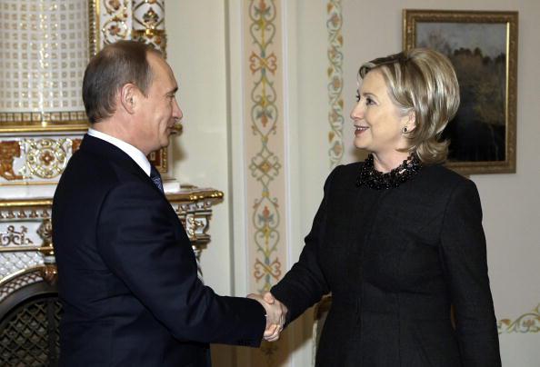 US Secretary of State Hillary Clinton (R) shakes hands with Russian Prime Minister Vladimir Putin (L) outside Moscow in Novo-Ogarevo on March 19, 2010. Photo credit: ALEXEY NIKOLSKY/AFP/Getty Images.