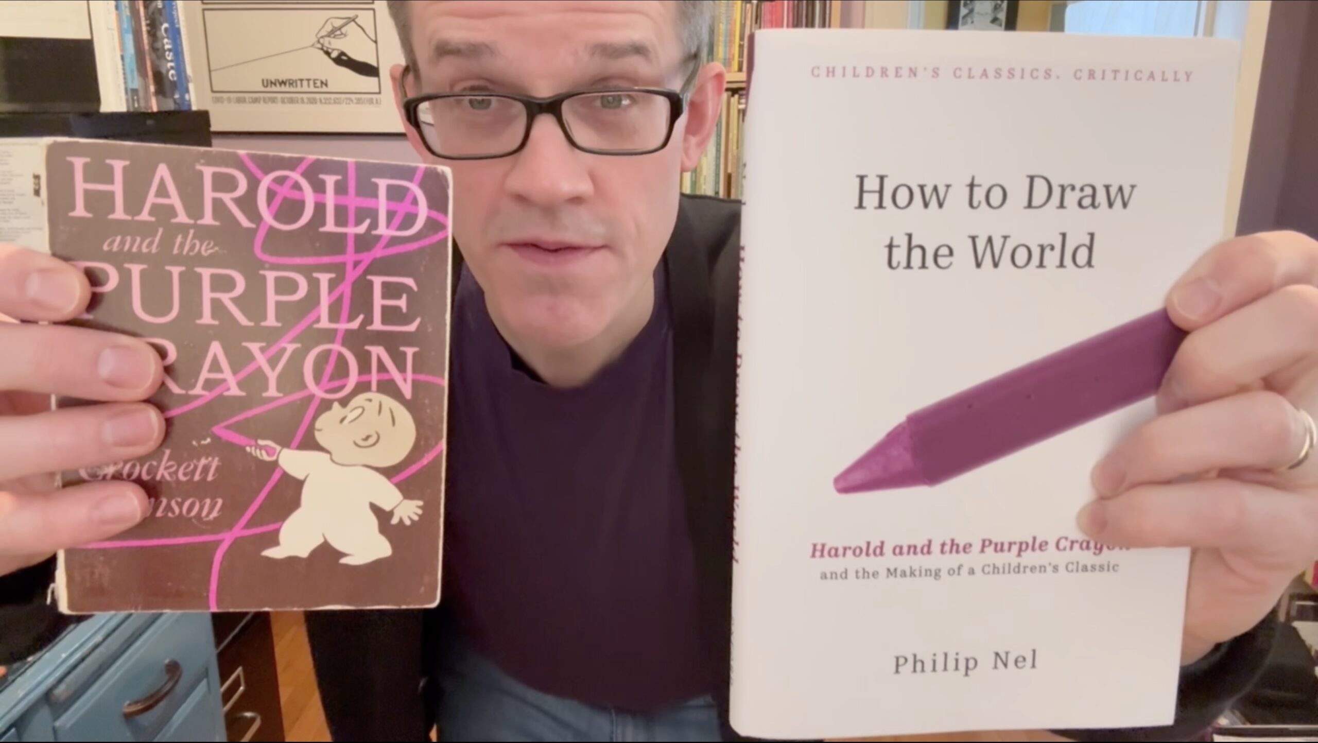 Phil Nel holds up 2 books: Harold and the Purple Crayon and How to Draw the World